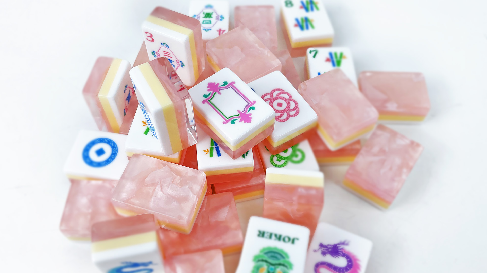 Pink pearlescent Mahjong tile backs with yellow middle layers and illustrated white faces