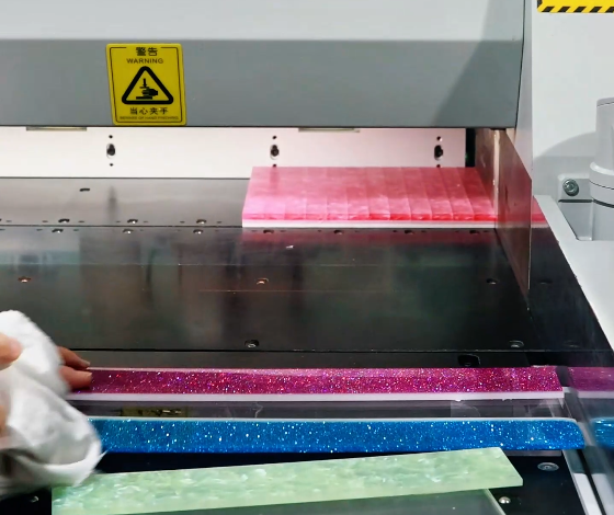 Cutting equipment with pink acrylic pieces and colored material strips