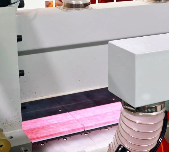 Shaping equipment positioned above pink acrylic tile blanks